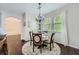 Cozy dining room with a chandelier, white curtains, and hardwood floors at 317 Water Oak Ln, Canton, GA 30114