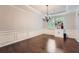 Classic dining room with dark hardwood floors, wainscoting, and elegant chandelier at 317 Water Oak Ln, Canton, GA 30114