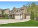Beautiful two-story home featuring a three car garage, stone accents, and manicured lawn at 317 Water Oak Ln, Canton, GA 30114