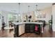 Open-concept kitchen with stainless steel appliances, granite countertops, and dark wood floors at 317 Water Oak Ln, Canton, GA 30114