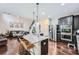 Open-concept kitchen with stainless steel appliances, granite countertops, and a large island at 317 Water Oak Ln, Canton, GA 30114