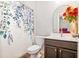 Bathroom with a floral shower curtain, vanity with dark wood cabinets, and a decorative mirror at 3200 Baylor Cir, Mcdonough, GA 30253