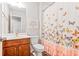 Bathroom boasts a vanity, toilet, and shower with a colorful butterfly curtain at 3200 Baylor Cir, Mcdonough, GA 30253