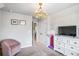 This bedroom has a chandelier, TV, a closet, and a pink chair at 3200 Baylor Cir, Mcdonough, GA 30253