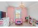 A bedroom has a pink theme, a trampoline, and a TV at 3200 Baylor Cir, Mcdonough, GA 30253