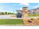 Stone community sign for Mathis Place at Pembrooke with landscaping in a beautiful setting at 3200 Baylor Cir, Mcdonough, GA 30253