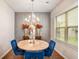Bright dining room with chandelier, a round table, and natural light from window at 3200 Baylor Cir, Mcdonough, GA 30253