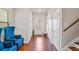 Inviting entryway with hardwood floors, blue chairs, and staircase offers a warm greeting at 3200 Baylor Cir, Mcdonough, GA 30253