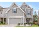 Charming home showcasing a well-manicured lawn, gray siding, and attached two-car garage at 3200 Baylor Cir, Mcdonough, GA 30253