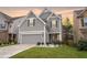 A two-story home features an attached garage, lush green lawn, and welcoming curb appeal at 3200 Baylor Cir, Mcdonough, GA 30253