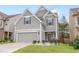 Charming home showcasing a well-manicured lawn, gray siding, and attached two-car garage at 3200 Baylor Cir, Mcdonough, GA 30253