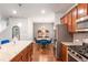 Stylish kitchen boasts stainless steel appliances and view into living room at 3200 Baylor Cir, Mcdonough, GA 30253
