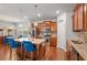 Open kitchen features granite countertops, pendant lighting, and access to the dining area at 3200 Baylor Cir, Mcdonough, GA 30253