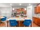 Open-concept kitchen featuring an island with granite countertops and stainless steel appliances at 3200 Baylor Cir, Mcdonough, GA 30253