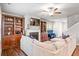 Spacious living room features built-in bookshelves, fireplace, ceiling fan, and plush sectional sofa at 3200 Baylor Cir, Mcdonough, GA 30253