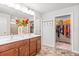 Elegant main bathroom featuring double vanity, open doorway to walk-in closet, and soft natural light at 3200 Baylor Cir, Mcdonough, GA 30253