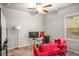 Bright home office featuring modern desk setup, window, and comfortable red chairs at 3200 Baylor Cir, Mcdonough, GA 30253