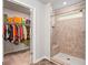 Spacious walk-in closet with ample shelving, storage, and open doorway to the luxurious shower at 3200 Baylor Cir, Mcdonough, GA 30253