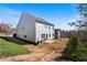 Spacious backyard featuring a covered patio, lush greenery, and a peaceful ambiance at 4225 Hopewell Manor Dr, Cumming, GA 30028