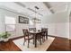 Dining room with a modern chandelier, detailed trim, and bright, natural light at 4225 Hopewell Manor Dr, Cumming, GA 30028