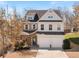 Charming two-story home with a two-car garage, brick and light blue siding and an inviting entrance at 4225 Hopewell Manor Dr, Cumming, GA 30028