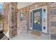 Cozy front porch featuring stone columns and a welcoming blue front door at 4225 Hopewell Manor Dr, Cumming, GA 30028