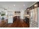 Gourmet kitchen featuring a spacious island, stainless steel appliances, and dark wood cabinetry at 4225 Hopewell Manor Dr, Cumming, GA 30028