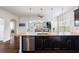 Modern kitchen open to the living room with a central island featuring a sink and barstool seating at 4225 Hopewell Manor Dr, Cumming, GA 30028