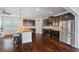 Well-appointed kitchen with stainless steel appliances, dark wood cabinets, and a large center island with seating at 4225 Hopewell Manor Dr, Cumming, GA 30028