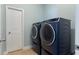 Bright laundry room featuring a modern washer and dryer set and a white door at 4225 Hopewell Manor Dr, Cumming, GA 30028
