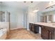 Spacious main bathroom featuring a double vanity, ceiling fan, and glass shower at 4225 Hopewell Manor Dr, Cumming, GA 30028