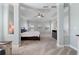 Spacious main bedroom featuring tray ceiling, ceiling fan, carpet, and large windows at 4225 Hopewell Manor Dr, Cumming, GA 30028