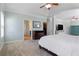 Spacious main bedroom featuring a large carpeted sitting area and a large ceiling fan at 4225 Hopewell Manor Dr, Cumming, GA 30028