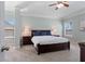 Bright main bedroom featuring tray ceiling, ceiling fan, carpet, and large windows at 4225 Hopewell Manor Dr, Cumming, GA 30028