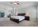 Bright main bedroom featuring tray ceiling, ceiling fans, carpet, and a sitting area at 4225 Hopewell Manor Dr, Cumming, GA 30028
