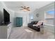 Sitting area with a couch, TV, and large windows overlooking the outdoors at 4225 Hopewell Manor Dr, Cumming, GA 30028