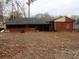A view of the backyard with a covered porch, with potential for outdoor living at 4269 Mercer Rd, Decatur, GA 30035