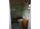 Small, outdated bathroom with green tile, a shower, and a sink vanity at 4269 Mercer Rd, Decatur, GA 30035