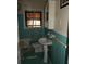Outdated bathroom features teal tile, pedestal sink, medicine cabinet, and broken window blinds at 4269 Mercer Rd, Decatur, GA 30035