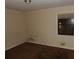 Small bedroom with stained carpet, dirty walls, and a window at 4269 Mercer Rd, Decatur, GA 30035