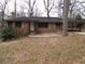 Charming single-story brick home featuring an open carport and front yard at 4269 Mercer Rd, Decatur, GA 30035