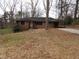 Charming single-story brick home featuring an open carport and front yard at 4269 Mercer Rd, Decatur, GA 30035