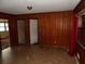 A view of the living room featuring a wooden accent wall and tile flooring at 4269 Mercer Rd, Decatur, GA 30035
