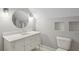 Attic bathroom featuring a modern vanity with round mirror and built in shelves at 2621 White Oak Dr, Decatur, GA 30032