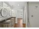 Elegant bathroom featuring a double vanity, modern lighting fixtures, and a subway tiled shower with a glass door at 2621 White Oak Dr, Decatur, GA 30032