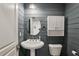 Cozy bathroom with rustic wood paneling, a pedestal sink, and a classic white toilet at 2621 White Oak Dr, Decatur, GA 30032
