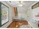 Cozy bedroom features sloped ceilings, hardwood floors, and bright light from large window at 2621 White Oak Dr, Decatur, GA 30032