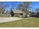 Home exterior with well-maintained lawn, long driveway, and a detached garage for convenience at 2621 White Oak Dr, Decatur, GA 30032