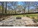 Large stone patio with a central fire pit, perfect for outdoor gatherings and relaxing evenings at 2621 White Oak Dr, Decatur, GA 30032