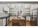 Modern kitchen featuring white cabinetry, stainless steel appliances, and a butcher block island at 2621 White Oak Dr, Decatur, GA 30032